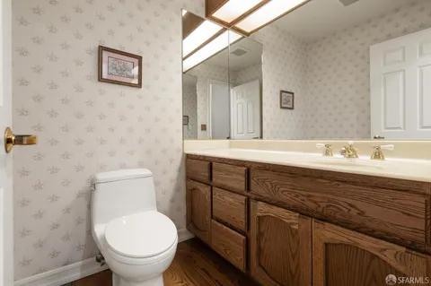 a kitchen with stainless steel appliances granite countertop a stove a sink dishwasher a refrigerator and cabinets with wooden floor