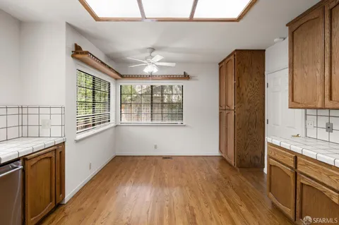 a view of a room with a ceiling fan and a window
