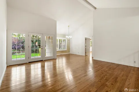 a view of a hallway with wooden floor and entryway