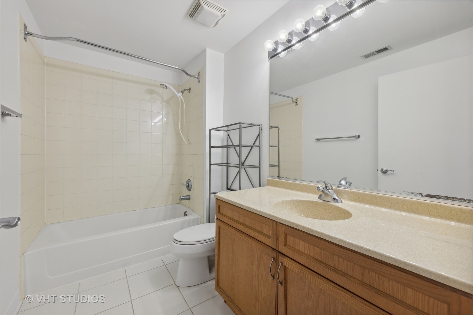 765 West 15th Street, Unit 309 Chicago, IL 60607 - Photo 9 of 14 a bathroom with a sink a toilet and shower