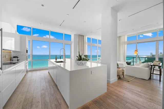 a kitchen with granite countertop a table and chairs in it