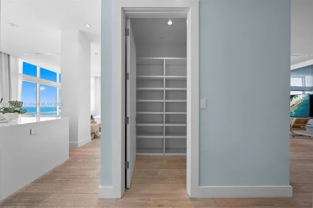 a view of a balcony with floor to ceiling windows and stairs