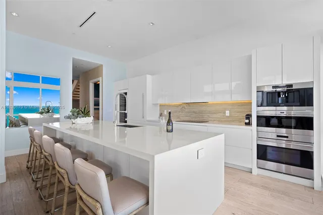 a living room with furniture and stairs