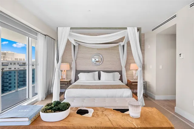 a bedroom with a bed and a painting on the wall