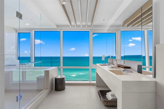 a bathroom with a granite countertop sink mirror vanity and toilet