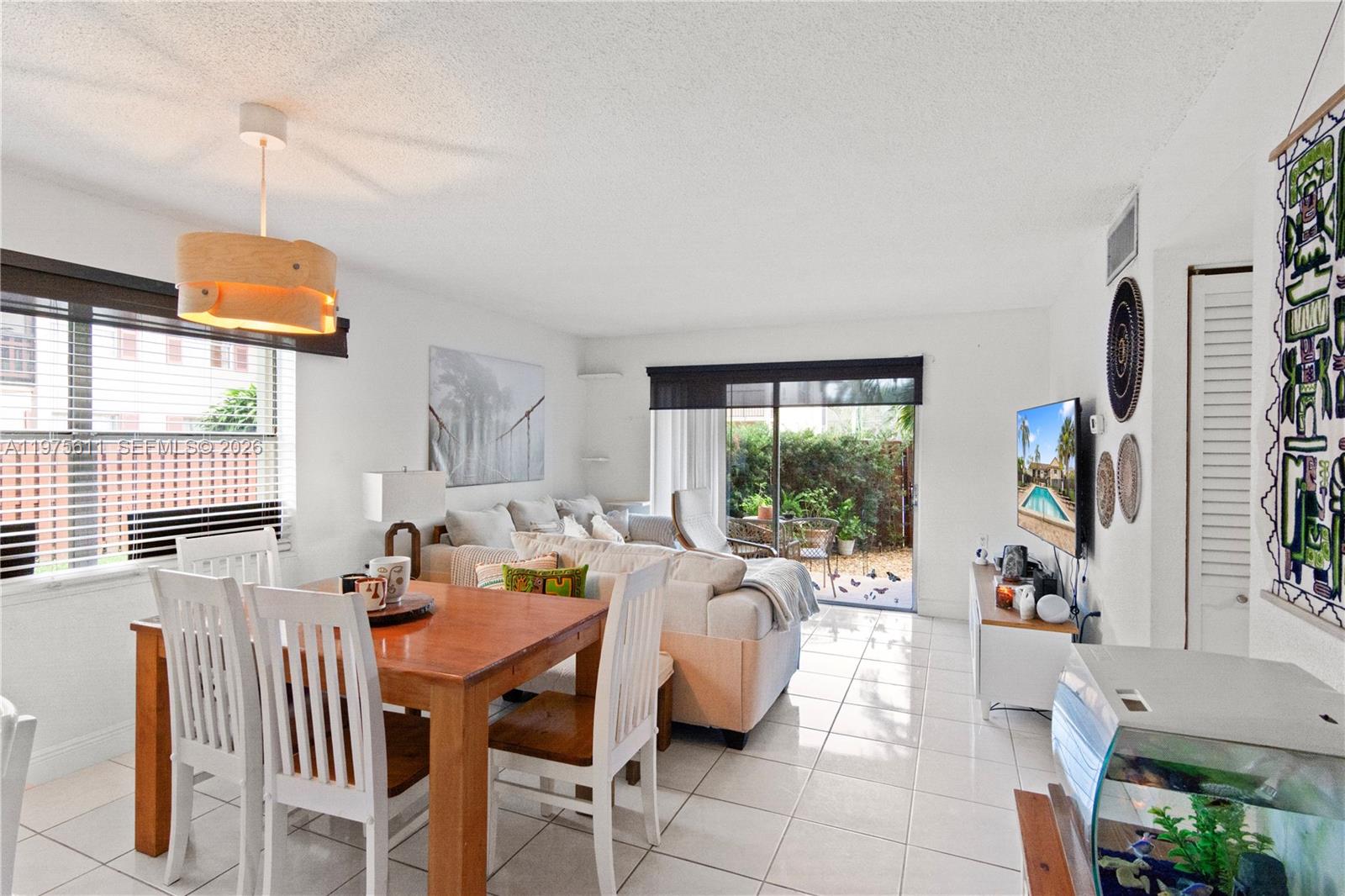 11209 Southwest 88th Street, Unit 101B Miami, FL 33176 - Photo 16 of 28 a view of a dining room with furniture window and outside view