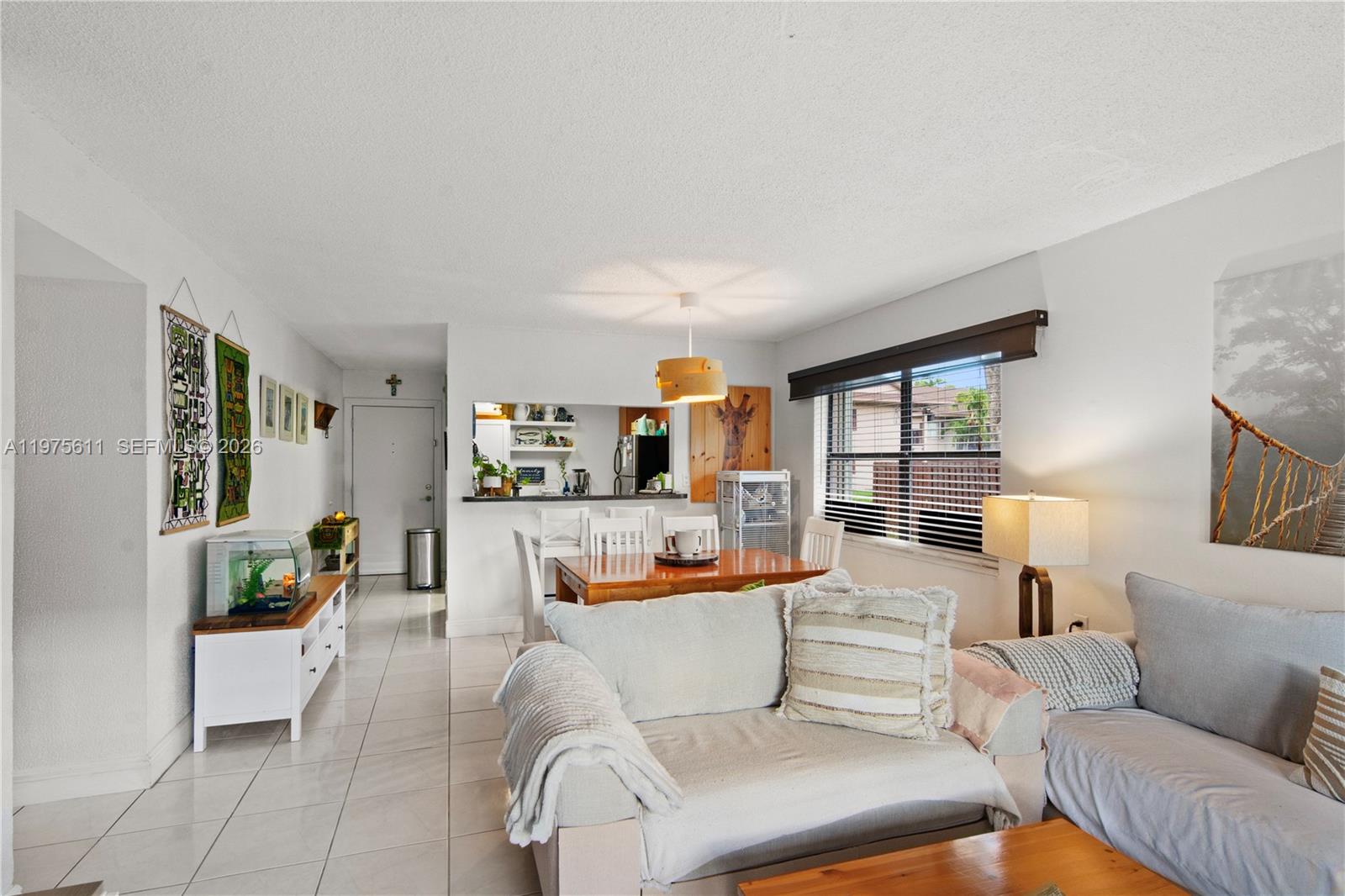 11209 Southwest 88th Street, Unit 101B Miami, FL 33176 - Photo 18 of 28 a living room with furniture and a table