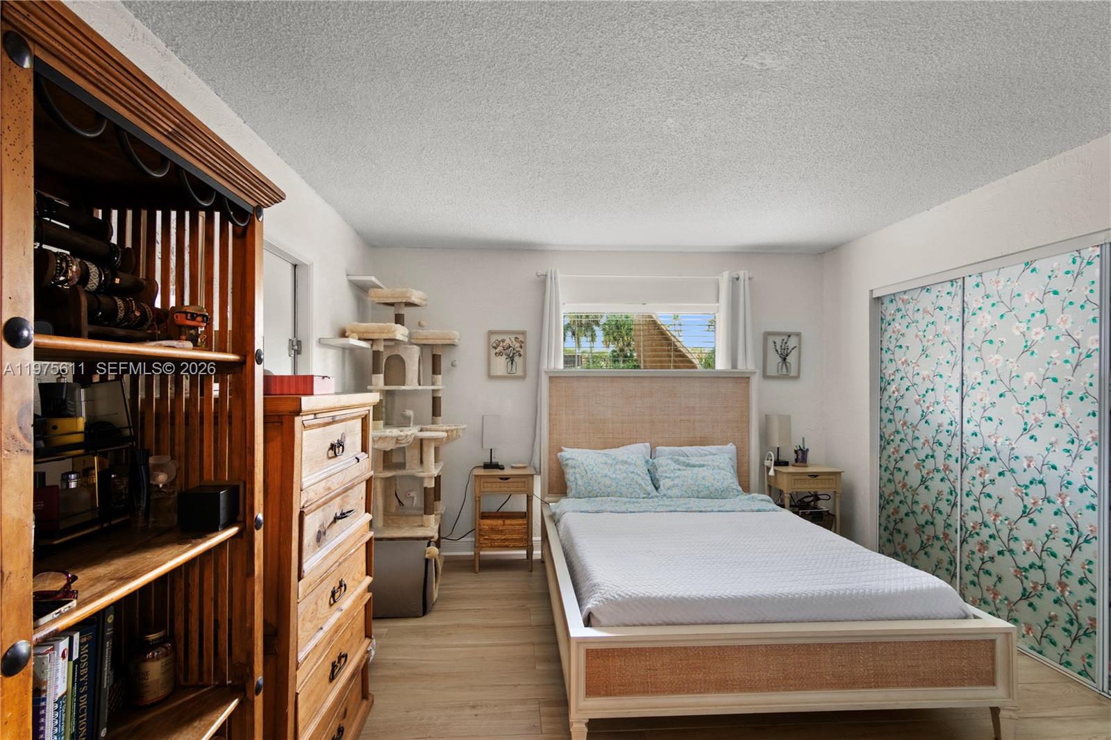 11209 Southwest 88th Street, Unit 101B Miami, FL 33176 - Photo 19 of 28 a bedroom with a bed and a window