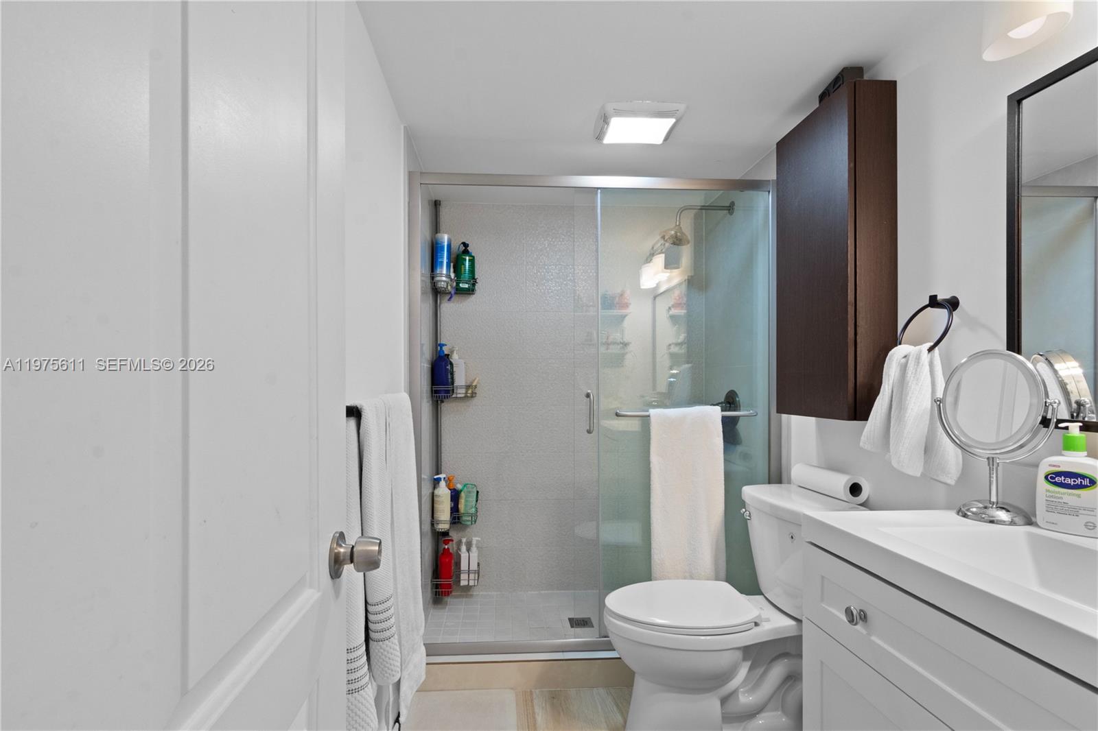 11209 Southwest 88th Street, Unit 101B Miami, FL 33176 - Photo 21 of 28 a bathroom with a sink toilet and shower