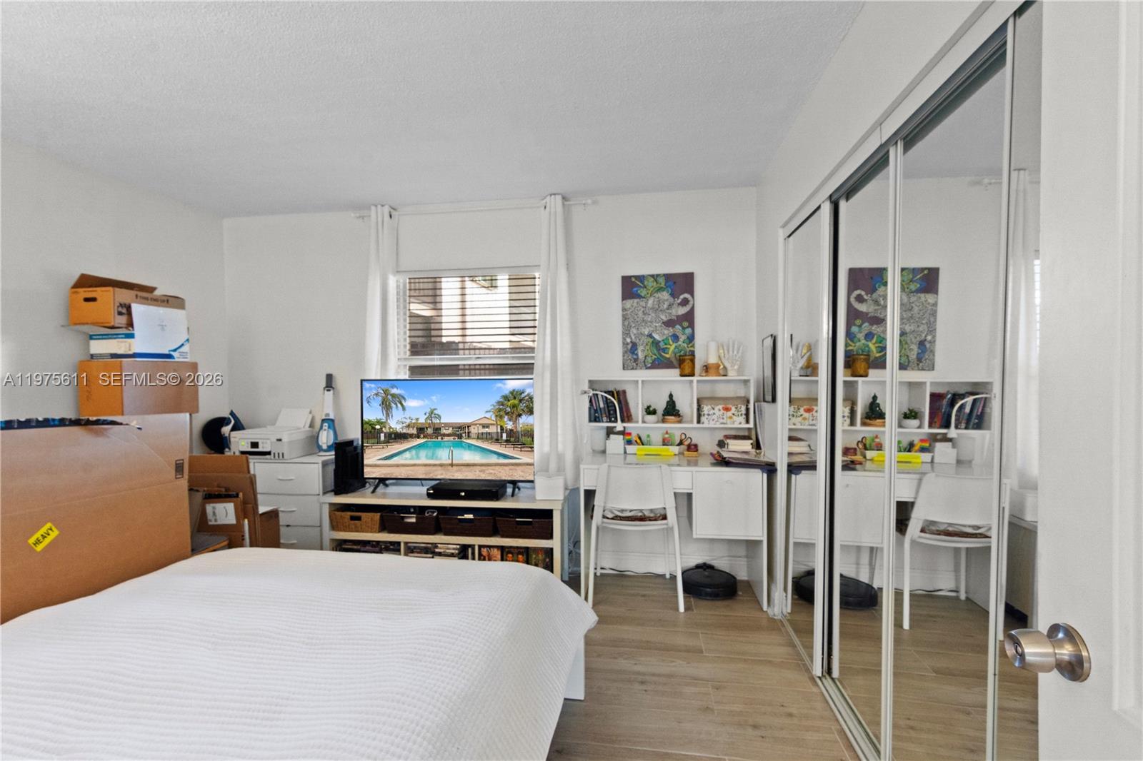 11209 Southwest 88th Street, Unit 101B Miami, FL 33176 - Photo 22 of 28 a bedroom with a bed and a desk