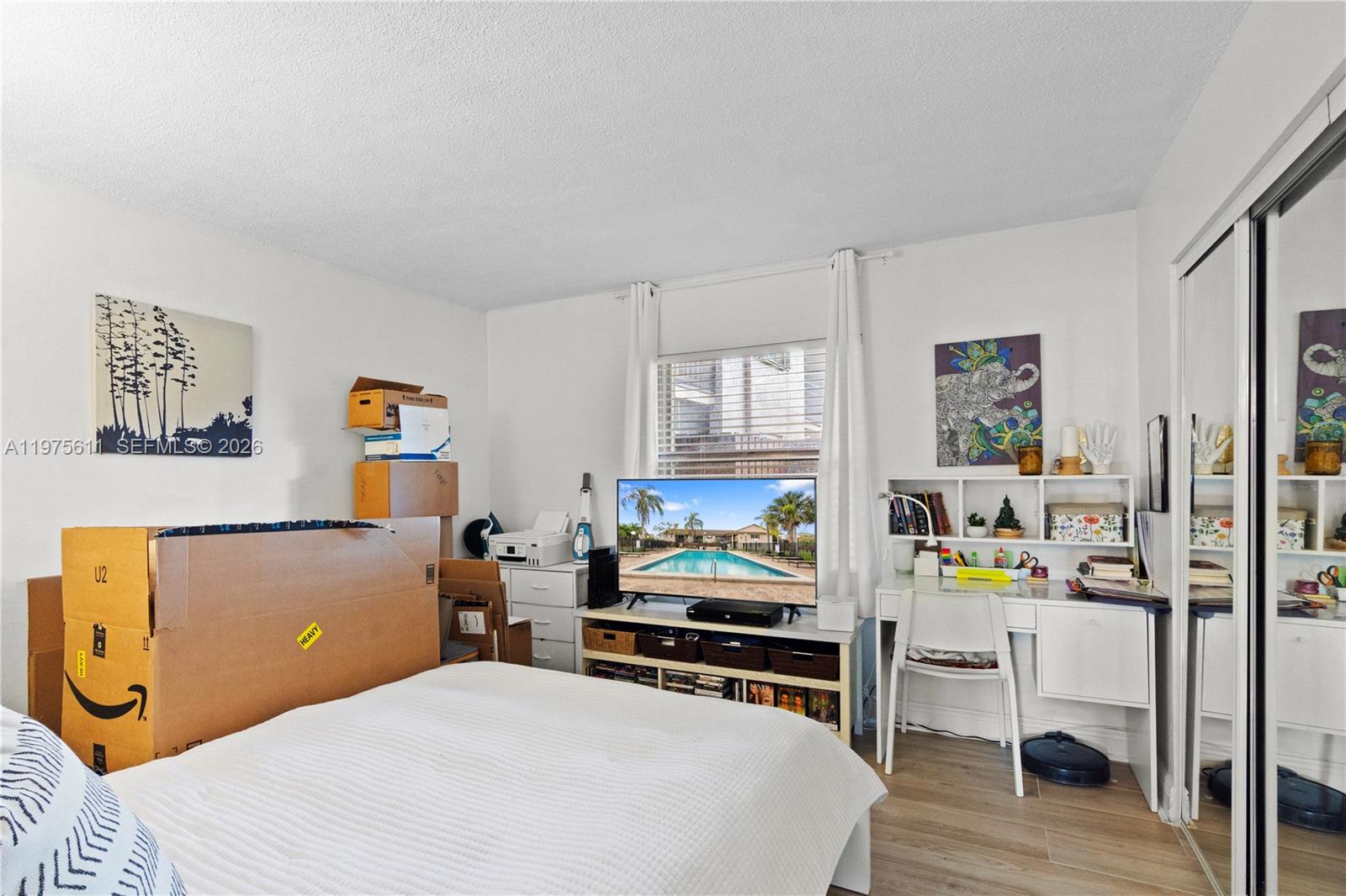 11209 Southwest 88th Street, Unit 101B Miami, FL 33176 - Photo 6 of 28 a bedroom with a bed a computer on desk and a chair