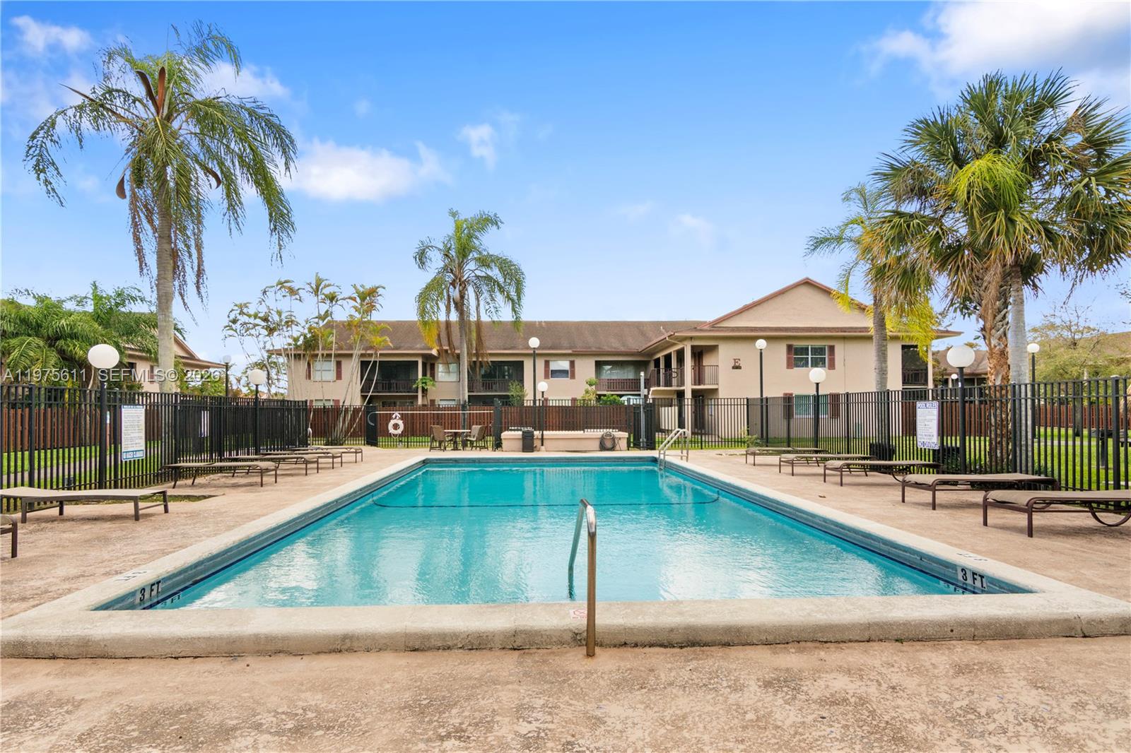 11209 Southwest 88th Street, Unit 101B Miami, FL 33176 - Photo 9 of 28 a view of a swimming pool with chairs