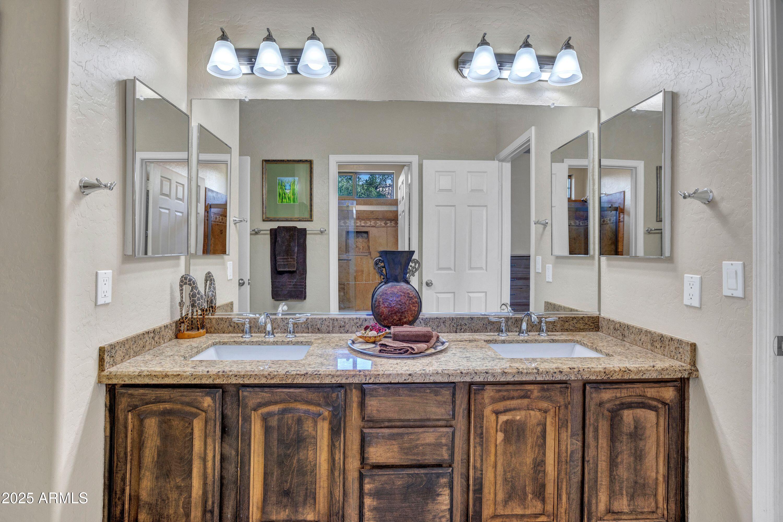 10655 East Acacia Drive Scottsdale, AZ 85255 - Photo 11 of 46 a bathroom with a sink double vanity and a mirror
