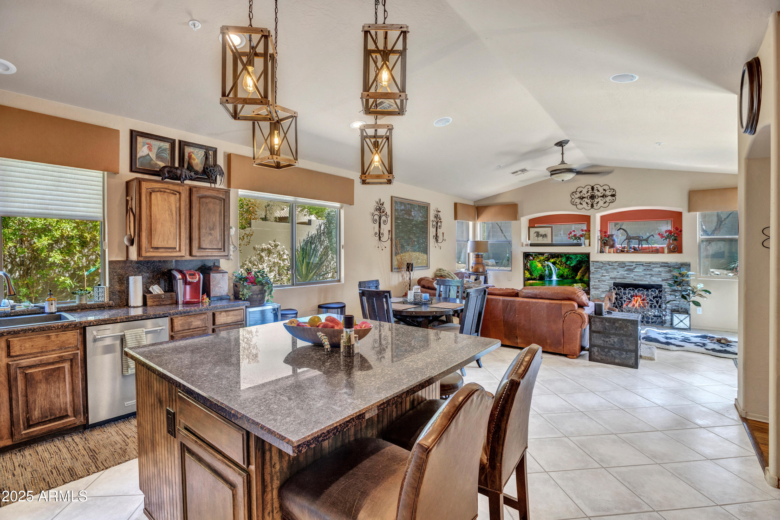10655 East Acacia Drive Scottsdale, AZ 85255 - Photo 13 of 46 a view of a dining room and livingroom with furniture wooden floor a rug a painting and a chandelier