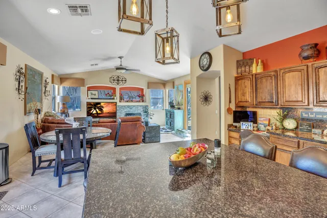 a living room filled with furniture kitchen view and a window