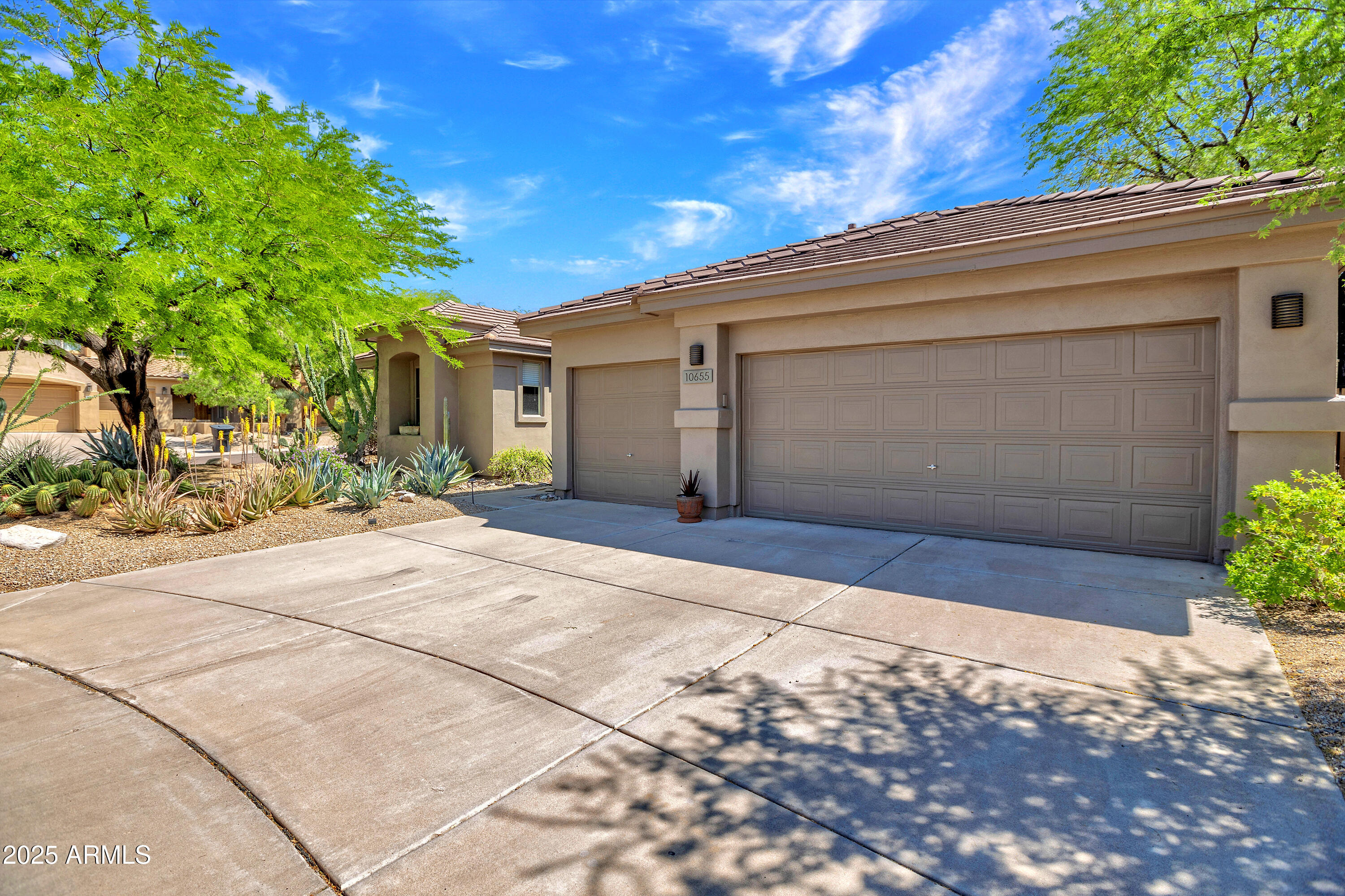 10655 East Acacia Drive Scottsdale, AZ 85255 - Photo 3 of 46 a front view of a house with a yard and garage
