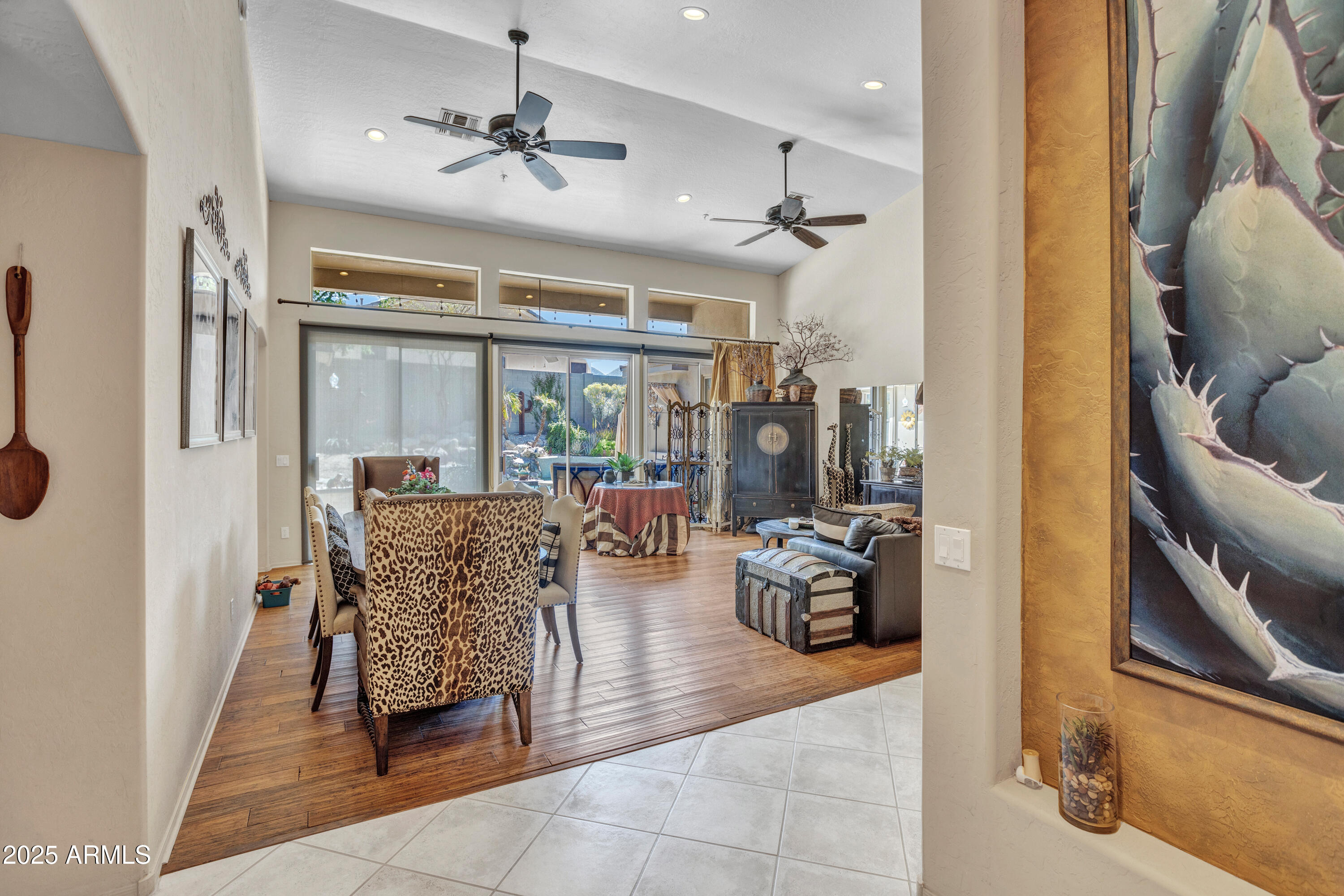 10655 East Acacia Drive Scottsdale, AZ 85255 - Photo 4 of 46 a living room with furniture and a chandelier