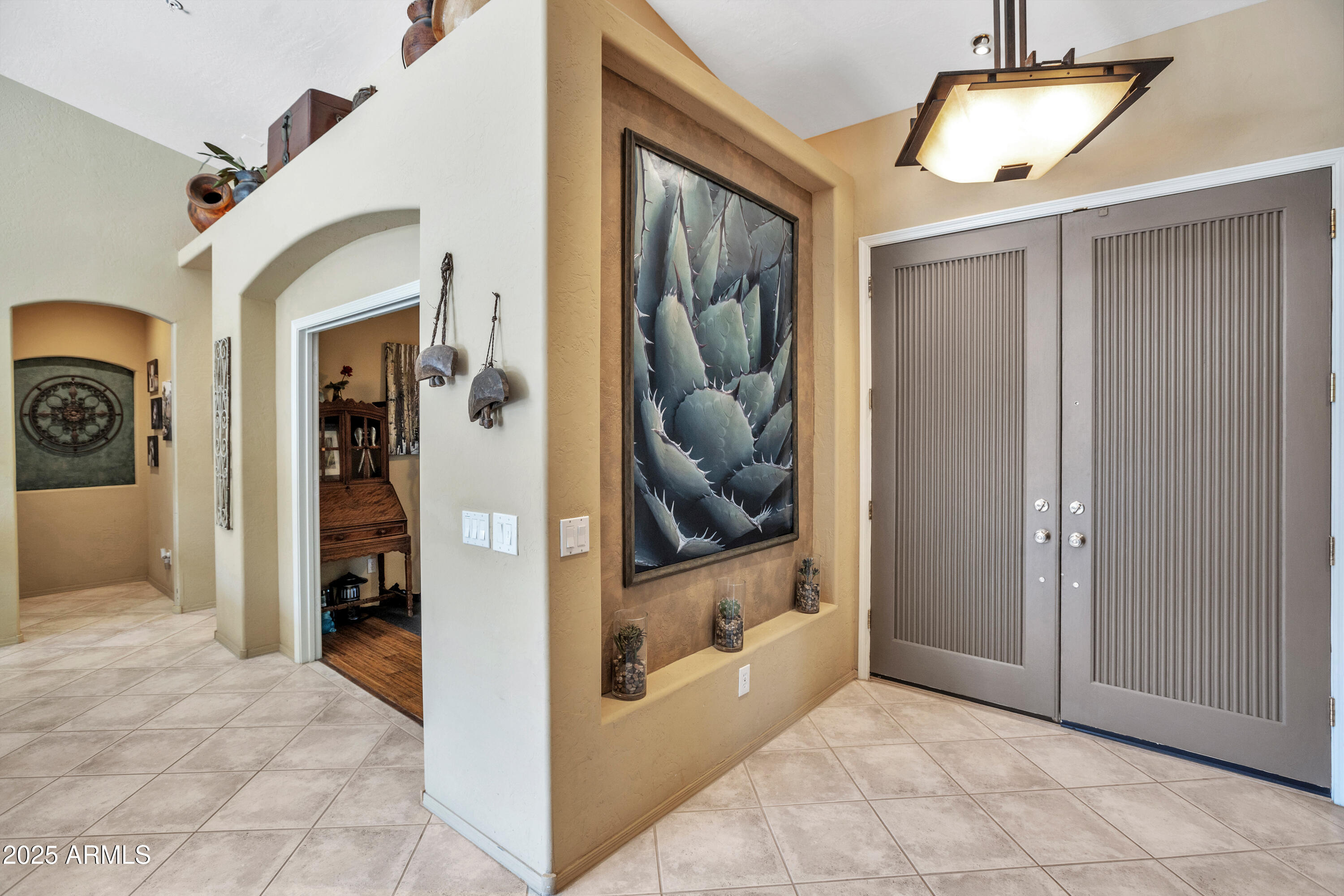 10655 East Acacia Drive Scottsdale, AZ 85255 - Photo 7 of 46 a view of a hallway with wooden shelves
