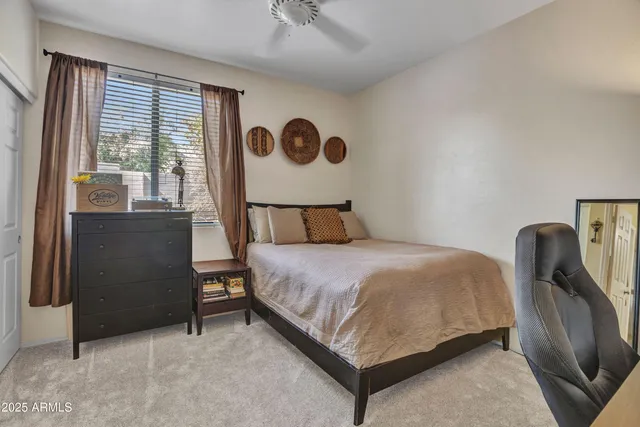 a bedroom with a bed and dresser