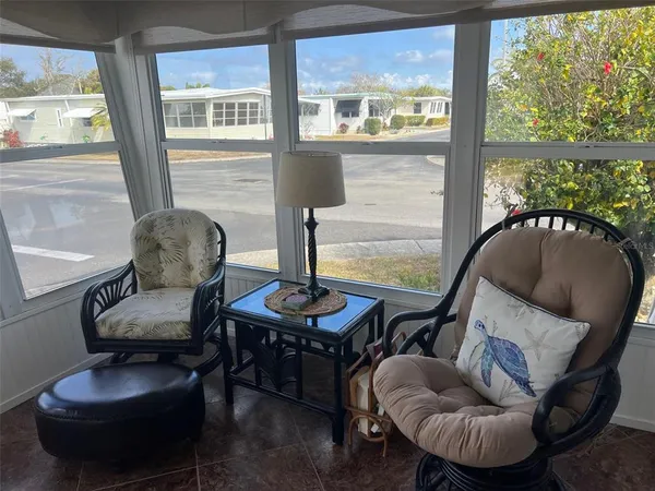 a living room with furniture and a floor to ceiling window