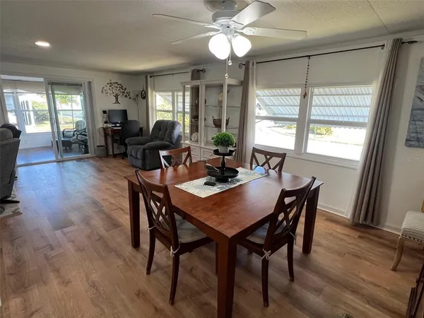 a view of a dining room with furniture window and wooden floor