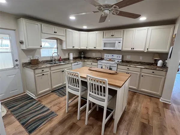 a kitchen with a stove a sink and a refrigerator