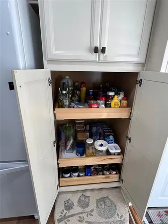 a kitchen with a stove and white cabinets