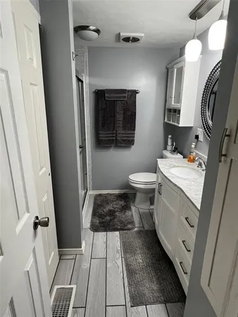 a bathroom with a sink toilet and shower