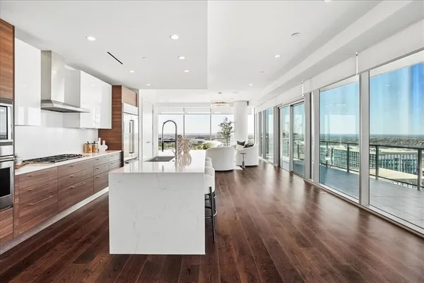 a kitchen with kitchen island a counter top space and wooden floor