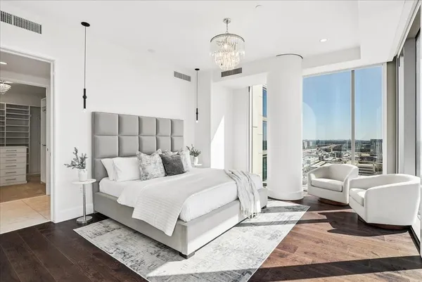 a spacious bedroom with a large window and a bed