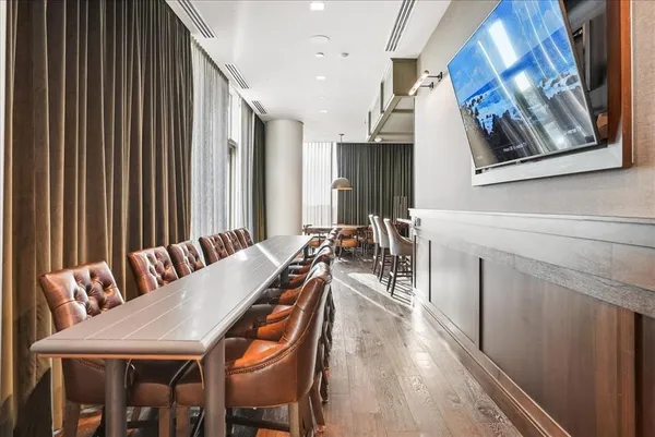 a room with furniture pool table and flat screen tv