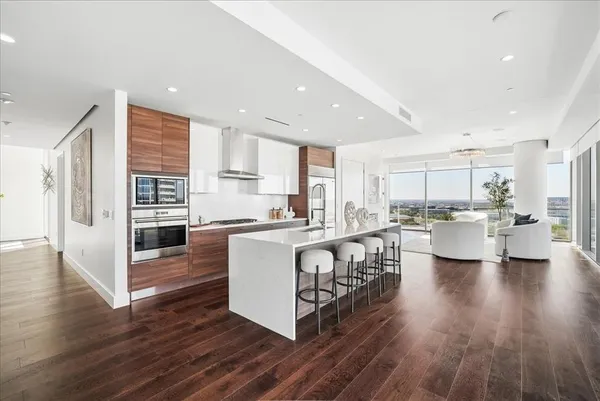 a large kitchen with a table and chairs in it
