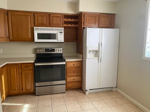 an empty room with wooden floor and a window