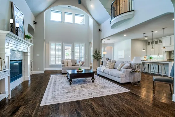 a living room with furniture a fireplace and a potted plant
