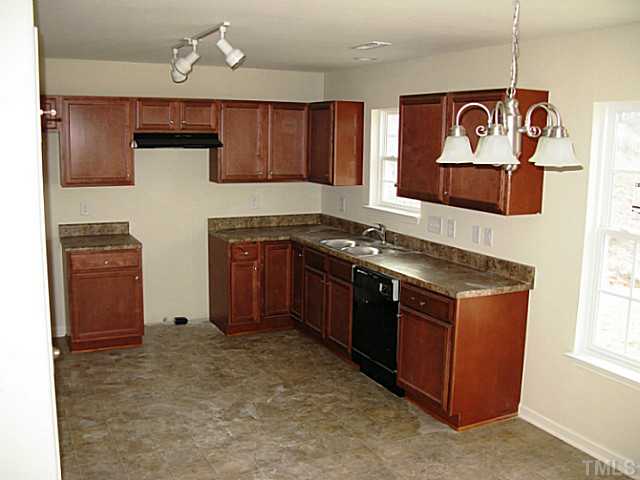 2717 Manthorp Terrace Raleigh, NC 27610 - Photo 5 of 16 a kitchen with stainless steel appliances granite countertop a stove and a refrigerator