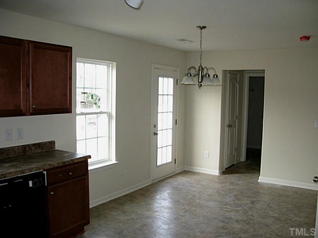 2717 Manthorp Terrace Raleigh, NC 27610 - Photo 6 of 16 a kitchen with a refrigerator and a stove top oven