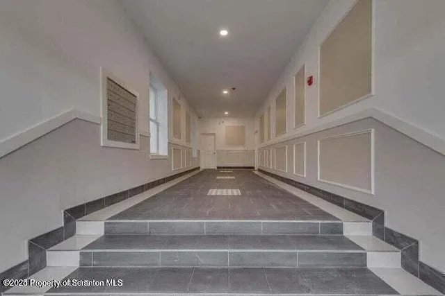 a view of entryway and hall with a front door