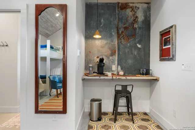 a view of a hallway with furniture and entryway