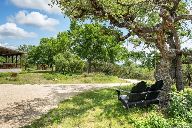 a view of a house with a backyard porch and sitting area