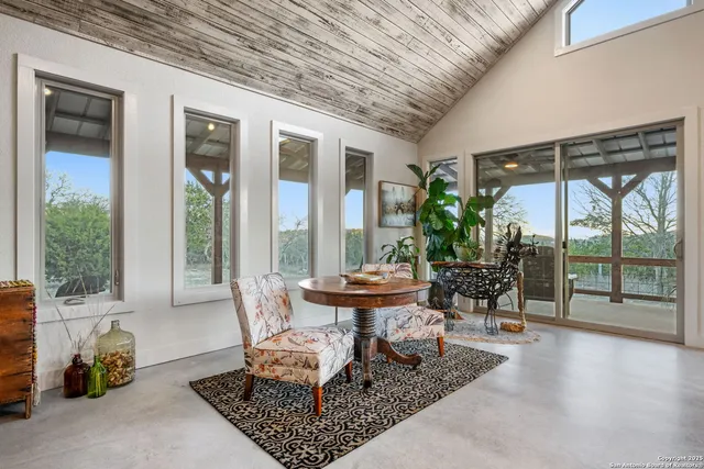 a room with lots of furniture a window and chairs