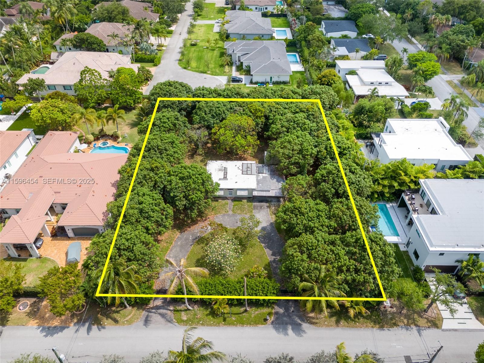 7800 Southwest 110th Street Pinecrest, FL 33156 - Photo 1 of 12 an aerial view of residential houses with outdoor space