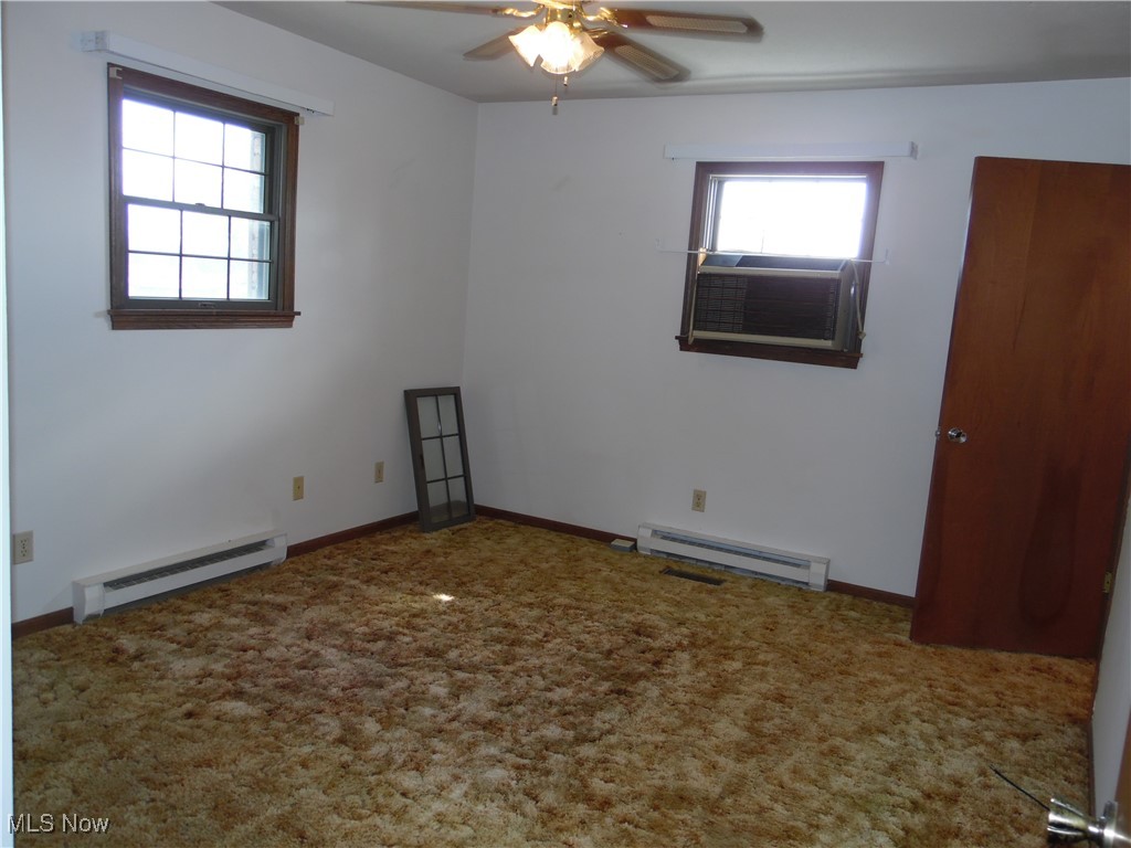 2800 Tick Ridge Road Lower Salem, OH 45745 - Photo 15 of 28 Spare room with baseboards, a baseboard heating unit, carpet flooring, and a ceiling fan