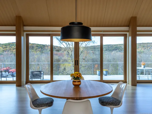 a living room with furniture and a floor to ceiling window