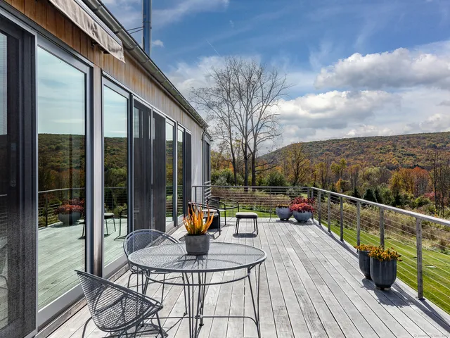 a outdoor view with sitting space and large trees