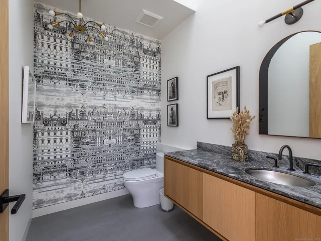 a bathroom with a granite countertop sink a toilet and bathtub