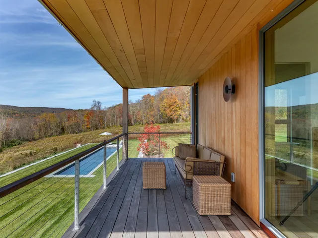 a balcony with furniture and wooden floor