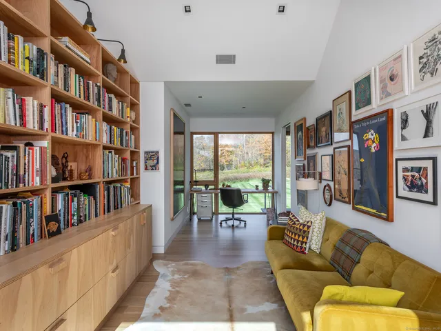 a living room with large lots of furniture and a book shelf