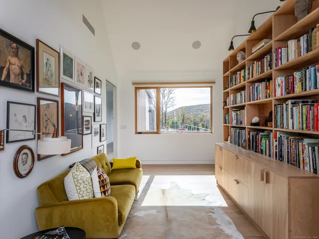 a living room with furniture and a book shelf