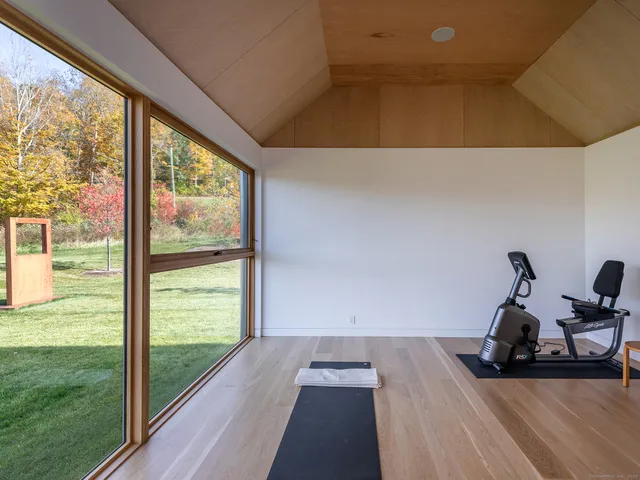 a view of a room with a bed and wooden floor