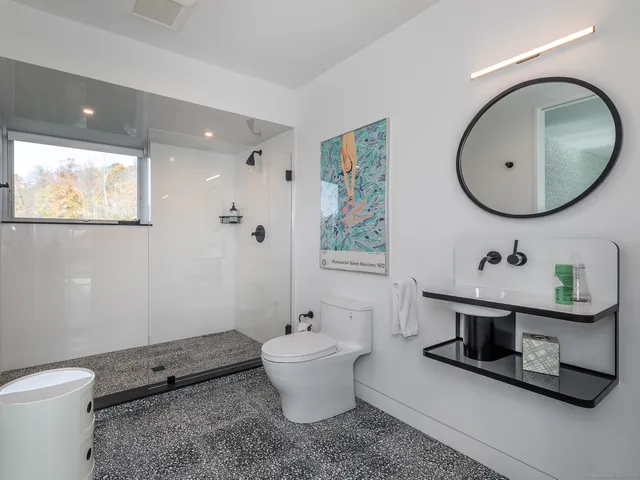 a bathroom with a toilet sink and mirror